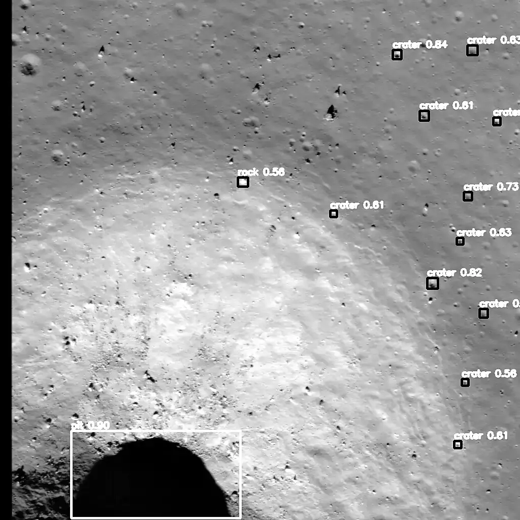 Detectron2 output on a bright, sloping crater wall: a pit at the lower edge boxed at 0.90, one rock at 0.56, and a line of small craters boxed at 0.56 to 0.84.